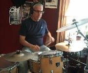Teacher John Knight playing drums