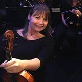 Teacher Theresa holding her violin
