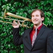 Teacher Kyle Malesevich holding his trombone