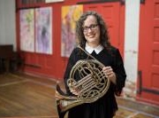 Teacher Emily Toth holding her french horn