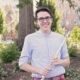 Teacher Isaiah Postenrieder holding a flute