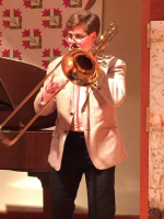 Teacher Michael Bourne playing a trombone.